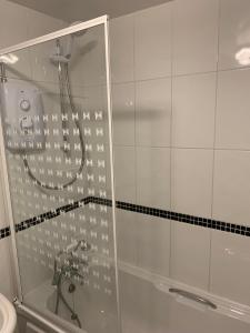 a bathroom with a shower with a glass door at Byre Cottages & Log Cabin in Cardigan +84 photos