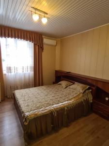 a bedroom with a bed and a window at Akropol in Gelendzhik