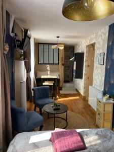 a bedroom with a bed and a living room with a piano at Chambre D'hôte Villa Maurice in Étretat