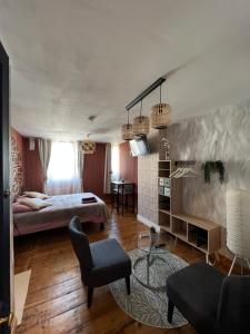 a bedroom with a bed and a living room at Chambre D'hôte Villa Maurice in Étretat