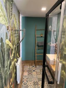 a bathroom with a blue wall and a staircase at Chambre D'hôte Villa Maurice in Étretat