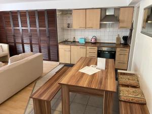 a kitchen with a wooden table and a couch at Messe Apartment Berlin in Berlin