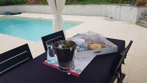 a table with a box of food and a drink on it at Le Peyroutet in Cazaux-Villecomtal