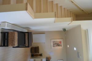 a living room with a staircase in a house at Meguminoyu in Furano