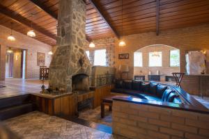 a living room with a couch and a fireplace at Hotel da Cachoeira in Penedo +46 photos