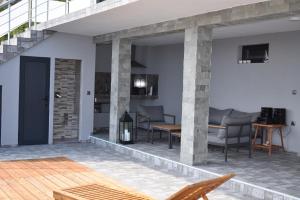 an outdoor patio with chairs and a table at Вила “Здравец” in Fish Fish