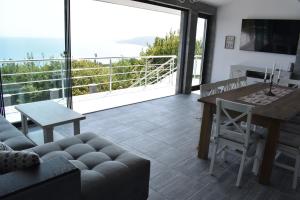 a living room with a couch and a table at Вила “Здравец” in Fish Fish