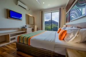 a bedroom with a bed and a large window at Skyloft Kandy by Aaradhya in Kandy