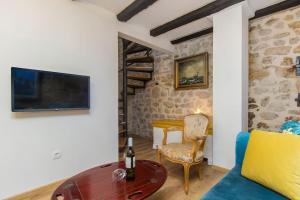 a living room with a couch and a table at Captain's Lodge in Tribunj