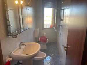 a bathroom with a sink and a toilet at Condominio Canaima in Bibione