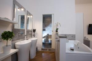 a bathroom with two white toilets and a sink at NAVONA VITA SUITES in Rome