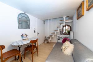 a living room with a couch and a staircase at Gastaldaga in Cividale del Friuli