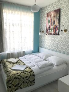 a bedroom with a white bed and white walls at Tulip Guesthouse in Istanbul