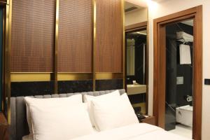 a bedroom with a bed with white pillows and a mirror at Henna Hotel Istanbul in Istanbul +90 photos