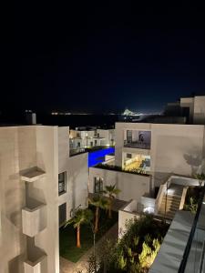 a view of a white building at night at Links II 505 Duplex 2bedroom Apartment GOLF Alcaidesa SPAIN in Alcaidesa