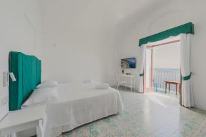 a bedroom with a bed and a window at Villa Nettuno in Positano