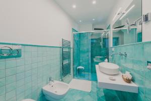 a bathroom with a toilet and a sink and a shower at Villa Nettuno in Positano