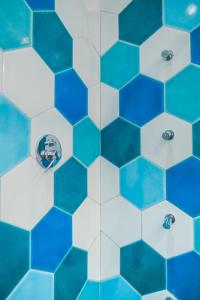 a bathroom with blue and white hexagonal tiles at Villa Nettuno in Positano