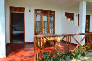 a balcony of a house with a staircase and some plants at Ella Infinity View in Ella
