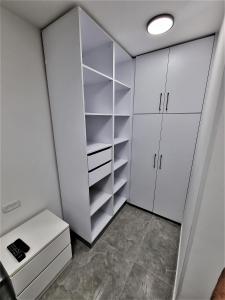 a white walk in closet with white cabinets at Diamond Suites Eilat in Eilat