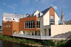 a house on the side of a river at Ambassador Hotel Eupen in Eupen