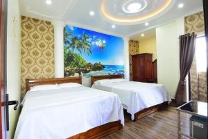 two beds in a bedroom with a view of the ocean at HAPPY GUEST HOUSE in Hai Phong