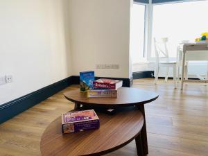 a table with boxes on top of it in a room at TYME Coastal Retreats - 1 and 2 Bedroom in Cleethorpes