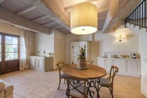 a kitchen and dining room with a table and chairs at Rivo della Corte in Pistoia