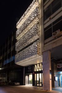 a building with lights on the side of it at Leochares Lifestyle Apartments - Self check-in in Athens