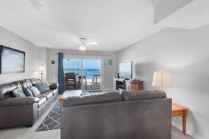 a living room with two couches and a table at Boardwalk D6 in Pensacola Beach