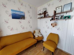 a living room with a couch and two chairs at Prie Masčio ežero in Telšiai