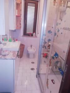 a bathroom with a shower and a sink and a toilet at Sole Sica in Pontecagnano