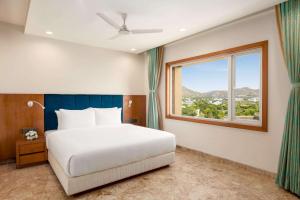 Ein Bett oder Betten in einem Zimmer der Unterkunft Howard Johnson by Wyndham Udaipur Roop Nagar