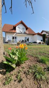 a house with a bunch of flowers in the yard at Ferienhaus Antiquarius in Bendorf