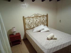 a bedroom with a bed with two towels on it at Kerasia's and Dora's garden in Punta