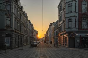 an empty street at sunset in a city with buildings at Bheaven I Jugendstil Premium Apartment in Bremerhaven