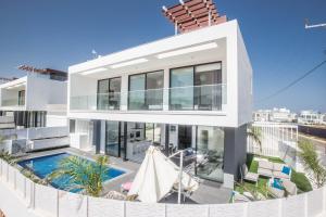 a large white house with a swimming pool at Anassa Seaview Villa - Stunning Panoramic Views in Protaras