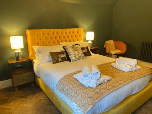 a bedroom with a bed with towels on it at Lletty by Orenda-Luxe in Llandudno