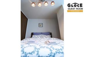- une chambre avec un lit et une couette bleue et blanche dans l'établissement GLOCE 横須賀 ゲストルーム 横須賀海軍基地 l Yokosuka Guest Room at NAVY BASE, à Yokosuka