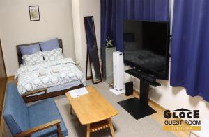 a living room with a bed and a television at GLOCE 横須賀 ゲストルーム 横須賀海軍基地 l Yokosuka Guest Room at NAVY BASE in Yokosuka