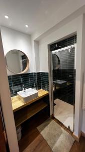 a bathroom with a sink and a mirror at Maison Stabatio Appartement Margot in Le Monêtier-les-Bains