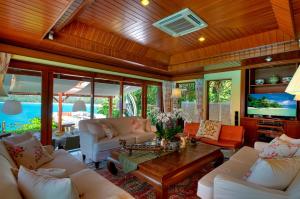 a living room with white furniture and a wooden ceiling at Dream Villa Double Bay Sunset on Andaman Sea in Kata Beach