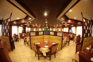a restaurant with tables and chairs in a room at RATHNA RESIDENCY in Coimbatore