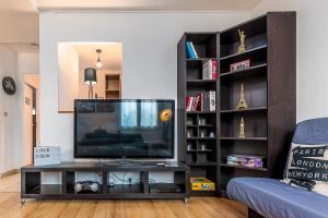 a living room with a television on a table at Paris Roissy CDG : Top Duplex - 3 bedrooms in Roissy-en-France