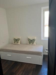 a bedroom with a bed with two butterfly pillows on it at Lumineux T3 avec vue Mer dans le Centre Historique in Sainte-Maxime