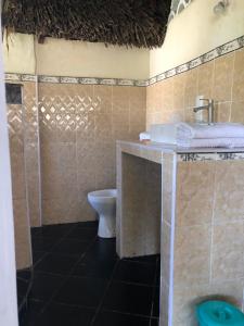 a bathroom with a sink and a toilet at Coconut Village Beach Resort in Diani Beach +108 photos