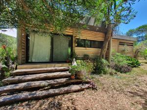 a house with a set of stairs in front of it at Chalet Los Troncos in Sauce de Portezuelo