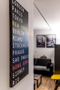 a painting hanging on a wall in a living room at Paris Roissy CDG : Top Duplex - 3 bedrooms in Roissy-en-France