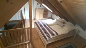 a bedroom with a bed in a room with a staircase at Ferienhaus "Am Schleifenbach" in Saalfeld