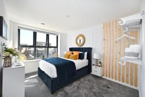 a bedroom with a bed and a window at Spacious Designer 2BR Executive Apt, Near Beach & Marina, Central Location in Kent